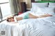 A woman laying on top of a bed in a bedroom.